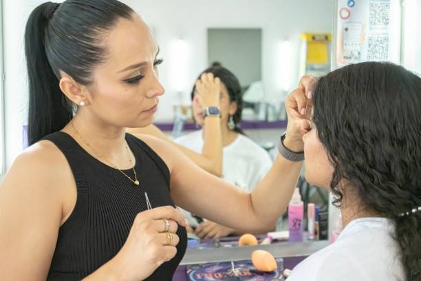 istock Make-up artist giving service to young people in her studio 2180574873