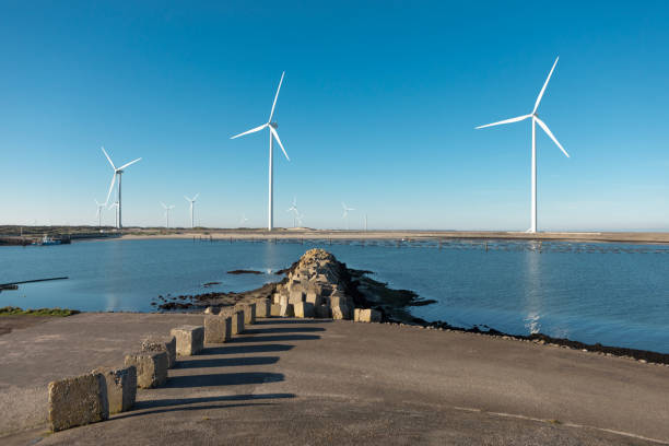 istock An engineer during his daily duties at a waterside windmill turbine power site 2180574978