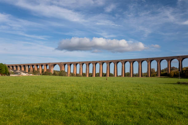 istock Railway viaduct across a green valley with a dramatic sky 2180579600