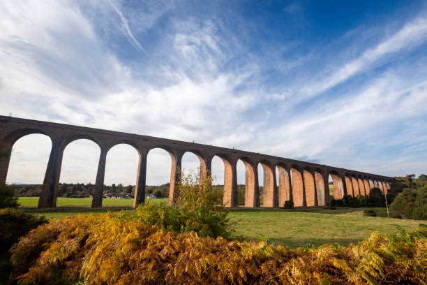 istock Railway viaduct across a green valley with a dramatic sky 2180579683