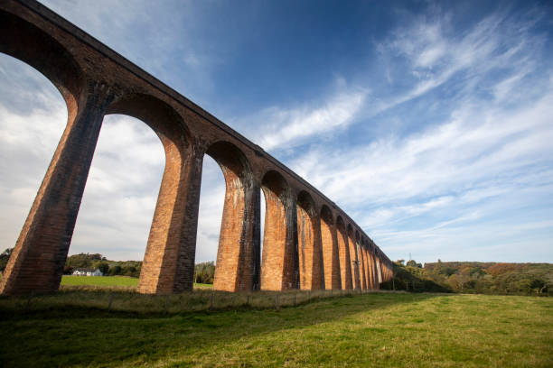 istock Railway viaduct across a green valley with a dramatic sky 2180579706