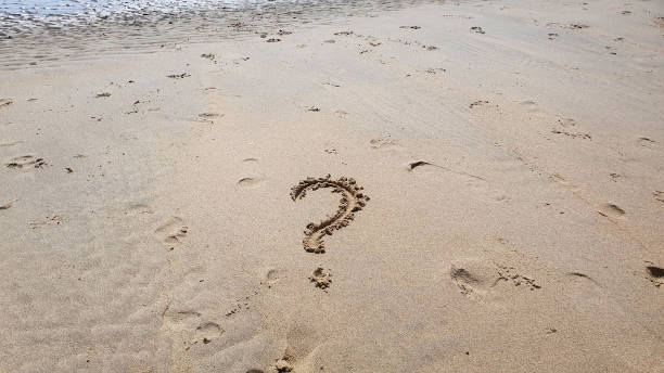 istock Question word on yellow sand background on the beach. 2180582505