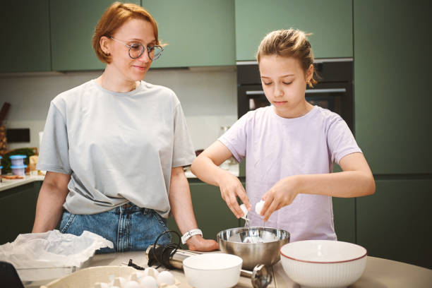 istock Mom and daughter cooks in the kitchen 2180582847