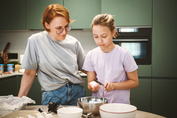 istock mother and daughter cooking in the kitchen 2180583352