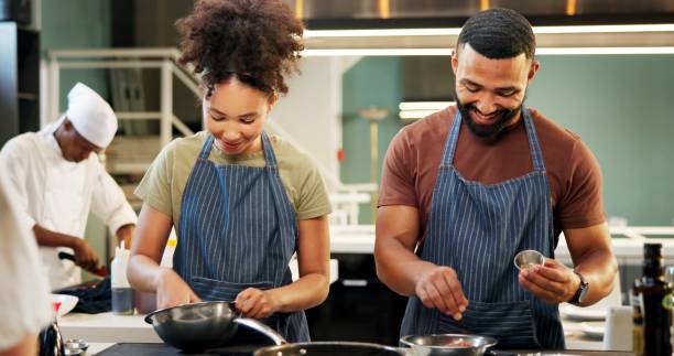 istock Cooking, students and learning in kitchen, chef and team with skills, culinary or preparation of meal. Restaurant, apprentice and people with recipe, smile and talent in hospitality, cuisine or apron 2180584736