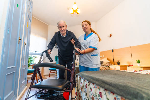 istock Senior man using walker assisted by nurse in the geriatrics 2180586702
