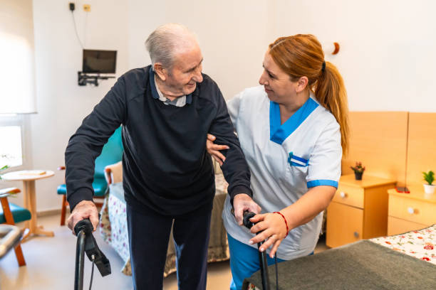 istock Nurse holding a man while walk in the nursing home 2180586716