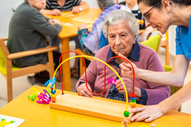istock Senior woman and physiotherapist playing skill board games 2180586836