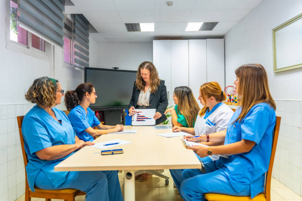 istock Manager of geriatrics talking with nurses at meeting room 2180586978