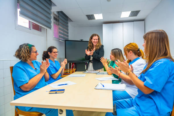 istock Healthcare workers applauding during work meeting in geriatrics 2180586984
