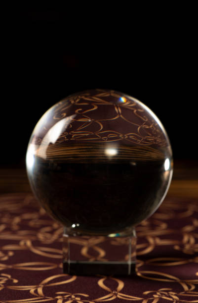 Crystal ball, scene with crystal ball and smoke, dark background. Selective focus.