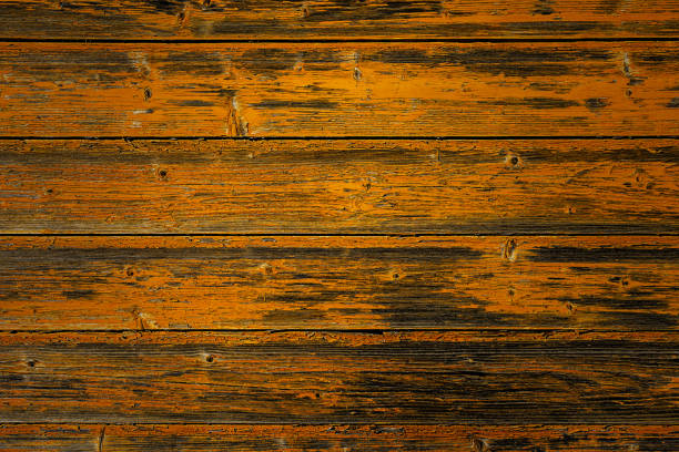 Rustic wooden wall made from horizontal planks with a worn, weathered texture, distressed look of the wood