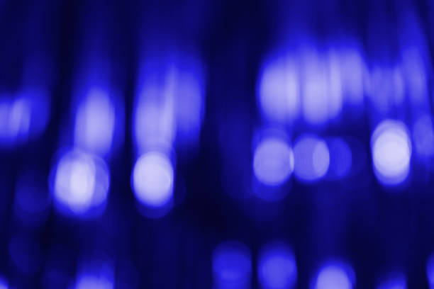 Blurred blue abstract background with light bokeh. Festive, Christmas, New Year, Valentine's or anniversary party. Decoration and holiday illumination concept