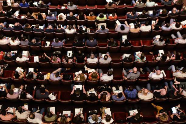 istock Theater audience with a view from above with almost all the seats occupied 2180593629