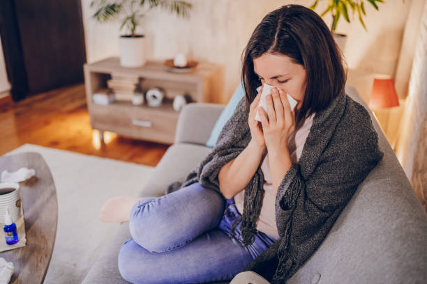 istock Sick woman sitting at home 2180594482