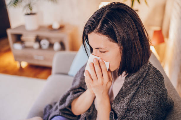 istock Sick woman sitting at home 2180594571