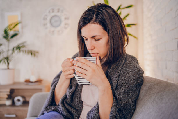 istock Woman with flu drinking hot tea 2180595356