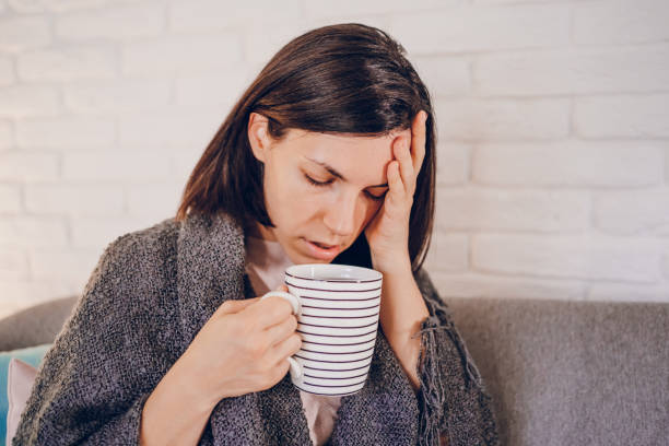 istock Woman with flu drinking hot tea 2180595452