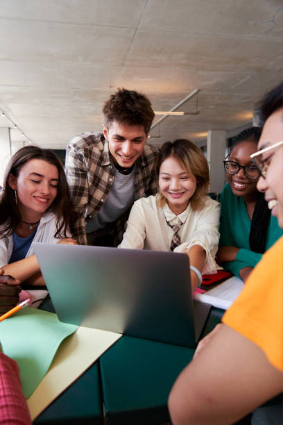 istock Multiracial group of university students sitting in the cafeteria studying together after classes. 2180599373