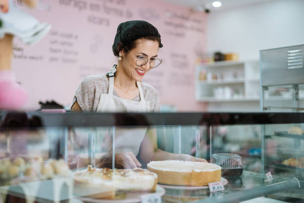 Waitress at the display of pies and sweets