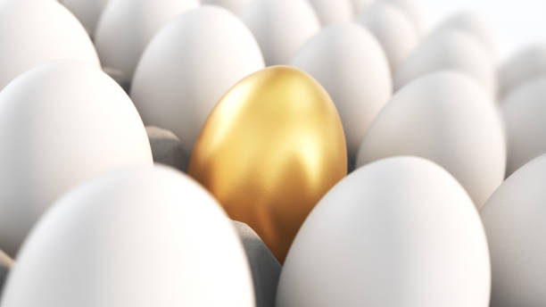 istock Golden Egg Selected Among White Eggs in Cardboard Boxes 2180614283