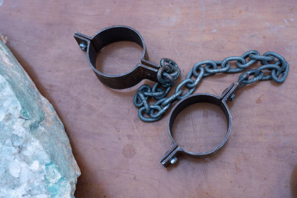 istock Ancient iron shackles of a slave with a chain 2180616106