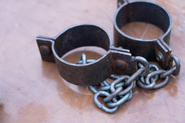 istock Ancient iron shackles of a slave with a chain 2180616117