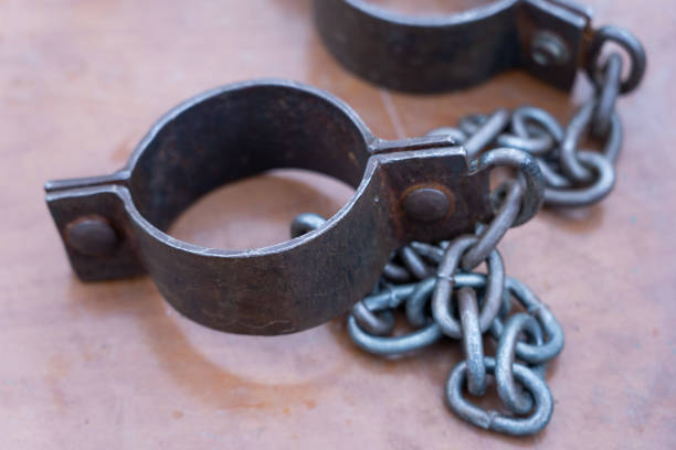 istock Ancient iron shackles of a slave with a chain 2180616124