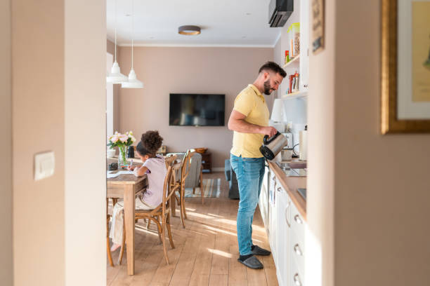 istock Diverse Father and Daughter Engaged in Studying and Cooking at Home 2180617396