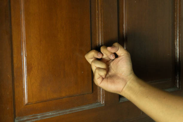 istock asian man's hand is knocking on the door 2180634805