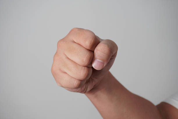 Woman using hand to stop man's punch from attack isolated on gray background.stop violence against women concept