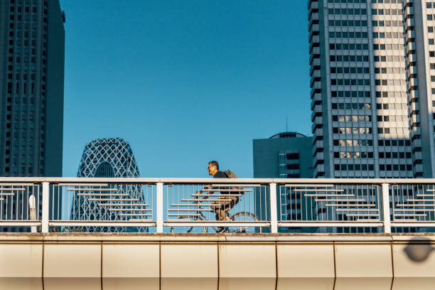 istock Mature businessman cycling through Tokyo 2180638658