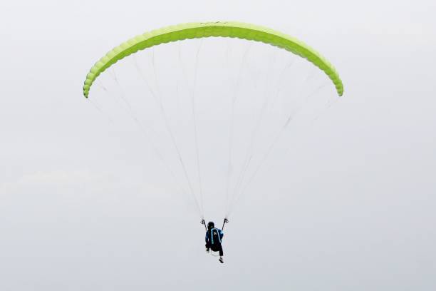 istock Paraglider pilot  flying high in blue sky 2180642865