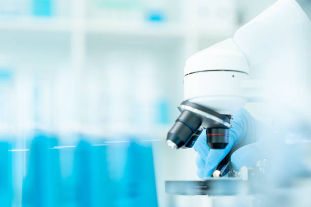 istock Scientist analyze biochemical samples in advanced scientific laboratory. Medical professional use microscope look microbiological developmental of viral. Biotechnology research in science lab. 2180645138