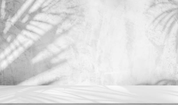 istock Backdrop white podium display for product. Interior room with sunlight and shadows on white concrete wall surface 2180646760