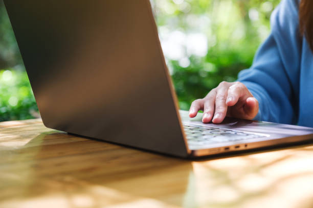 istock Closeup image of a woman working and touching on laptop computer touchpad 2180648265