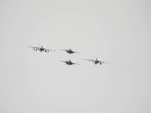 Air Force Day. Aircraft silhouettes on background of sunset. Combat flight of interceptors on a mission.