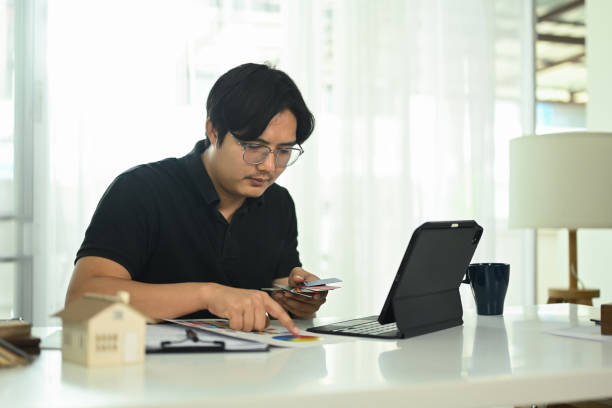 istock Architect working on a design proposal with color palettes at creative workspace 2180649560