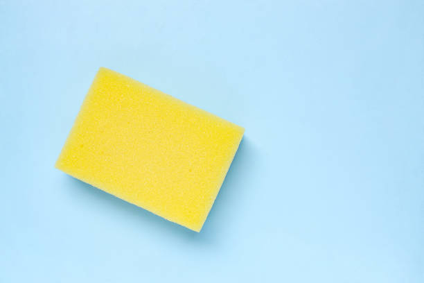 istock Yellow cleaning sponge on light blue background. 2180654158