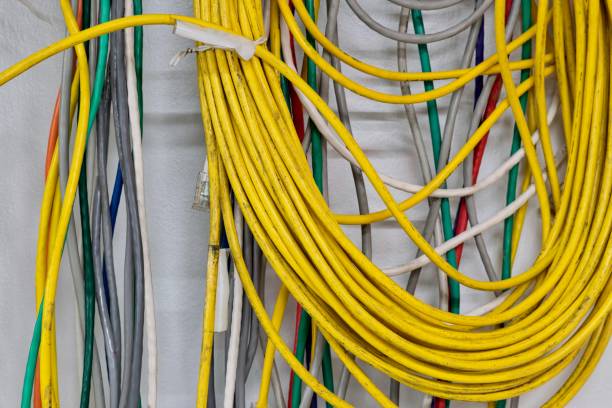 istock Colorful electrical cables hanging wall CAT5 Twisted pair cables. 2180656288