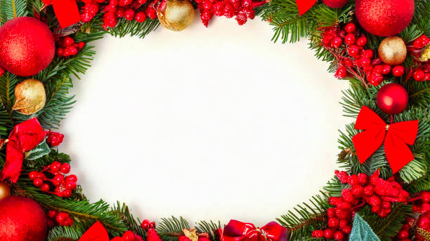 istock Christmas wreath border frame with white copy space. Christmas wreath border with red bows, traditional decorations and berries. Space for copy 2180661400