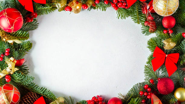 istock Christmas wreath border frame with white copy space. Christmas wreath border with red bows, traditional decorations and berries. Space for copy 2180661412