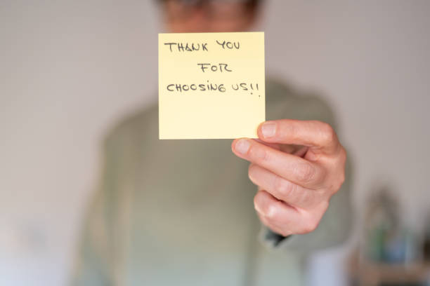 istock Hand Holding Sticky Note With 'Thank You For Choosing Us' Message 2180667412