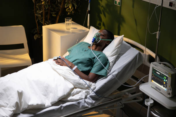 istock Woman in hospital, African, using oxygen mask, resting peacefully 2180670104