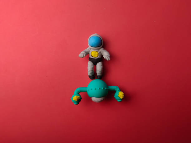 Top view spaceman and space ship on a red background.