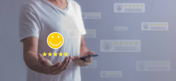 istock Experience;  Review, Young Man using smartphone mobile hand holding five star and emoji to review and give 5 stars with very good results in service, Good review 5 star rating choice feedback 2180673056