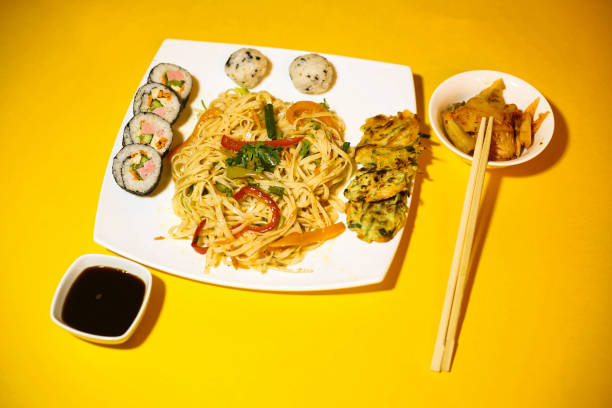 istock Korean Noodle Dish With Kimchi and Sushi Rolls 2180674530