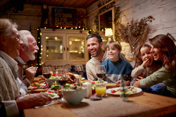 istock Happy extended family talking during lunch in dining room. 2180675413