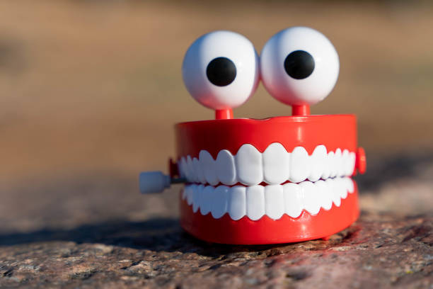 Plastic teeth in colored lighting.