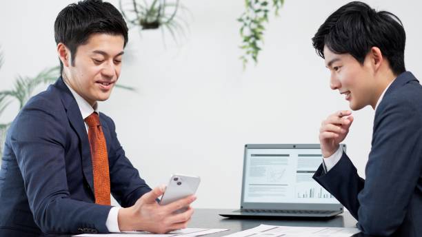 istock Businessman using smartphone at a meeting 2180675805